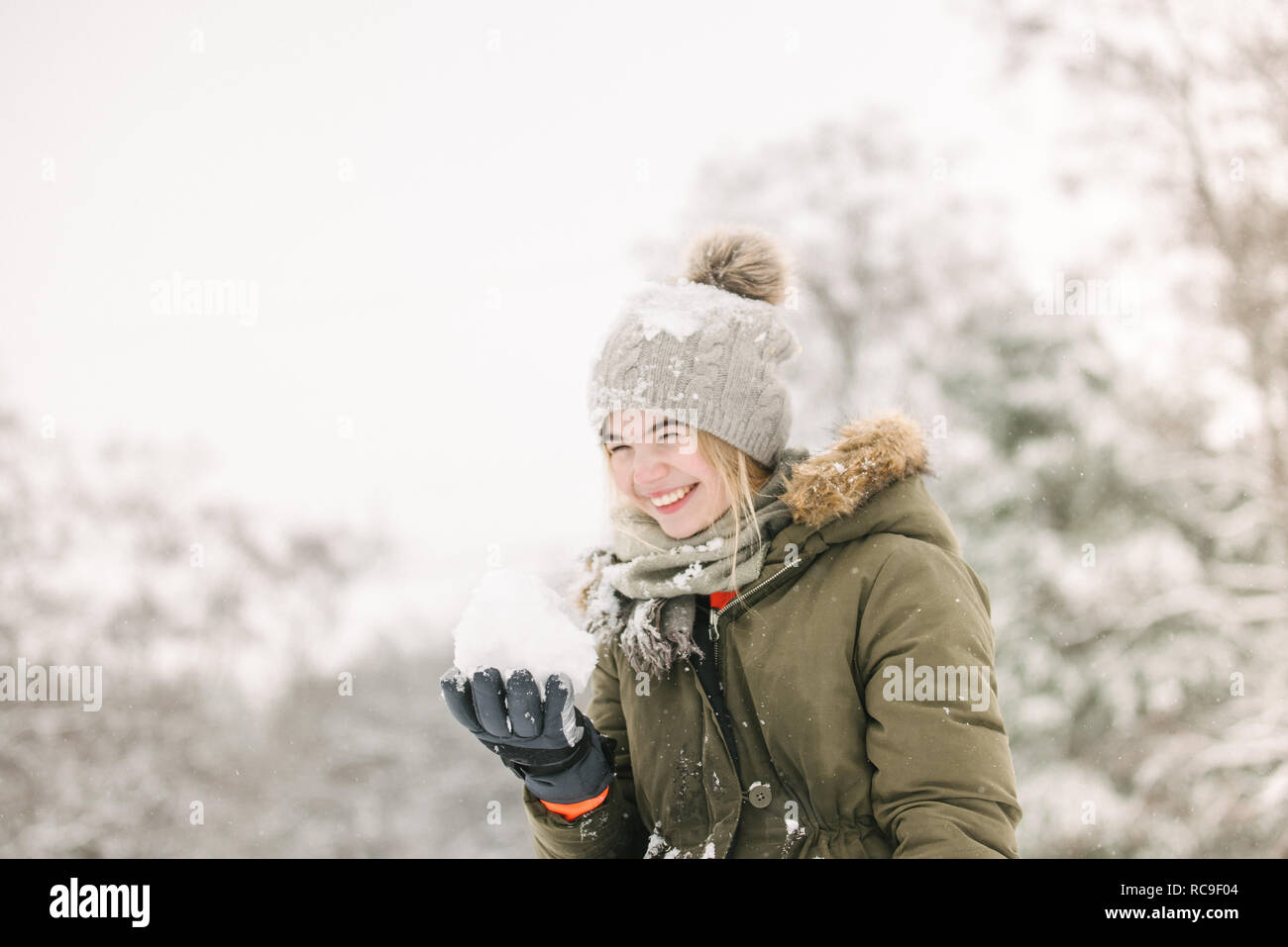 Girl with snow ball in winter landscape Stock Photo