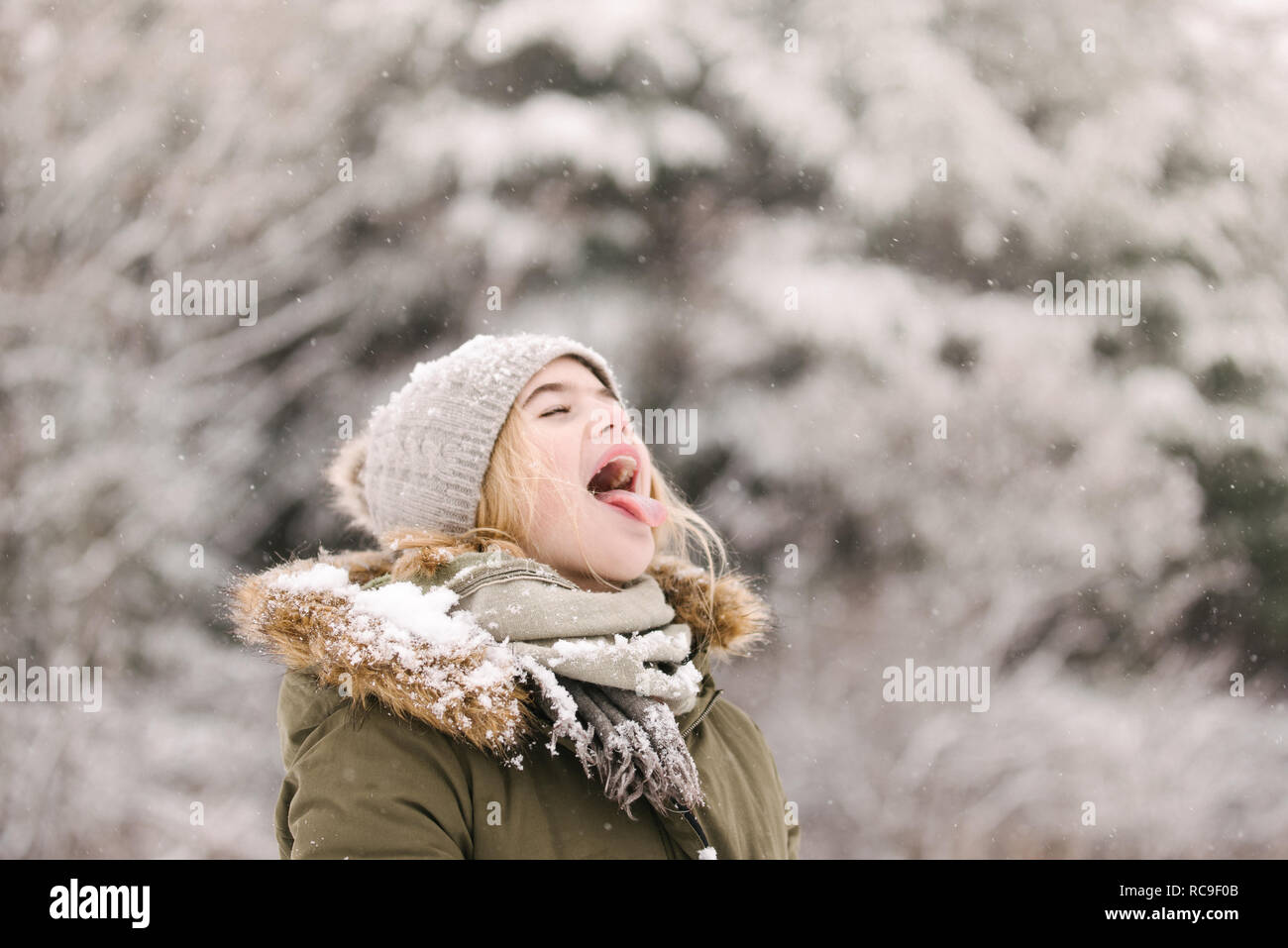 Girl with mouth open waiting for snow Stock Photo