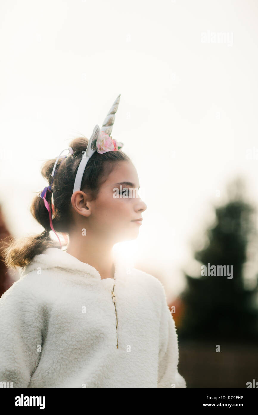 Girl with unicorn hairband in park Stock Photo