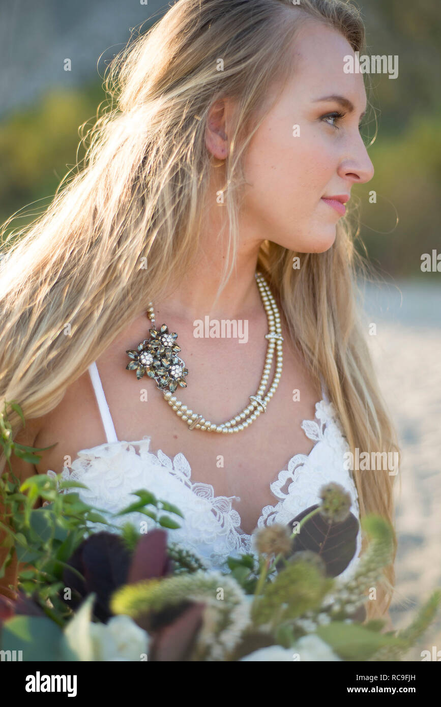 Bride with bouquet on beach Stock Photo - Alamy