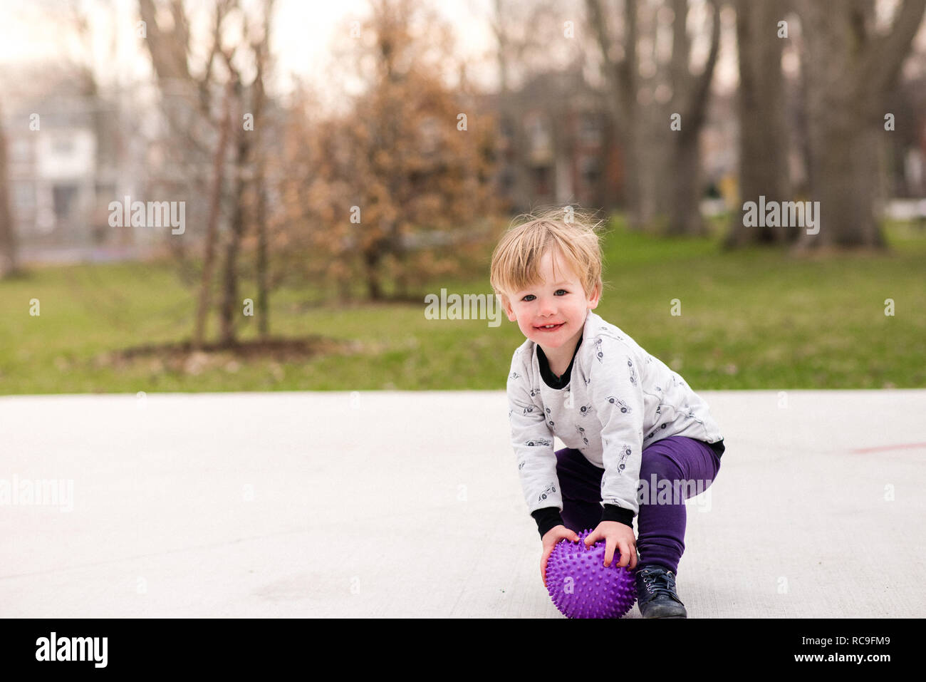 Boy playing ball in park Stock Photo