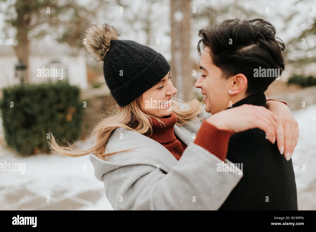 Couple hugging in snowy landscape, Georgetown, Canada Stock Photo - Alamy