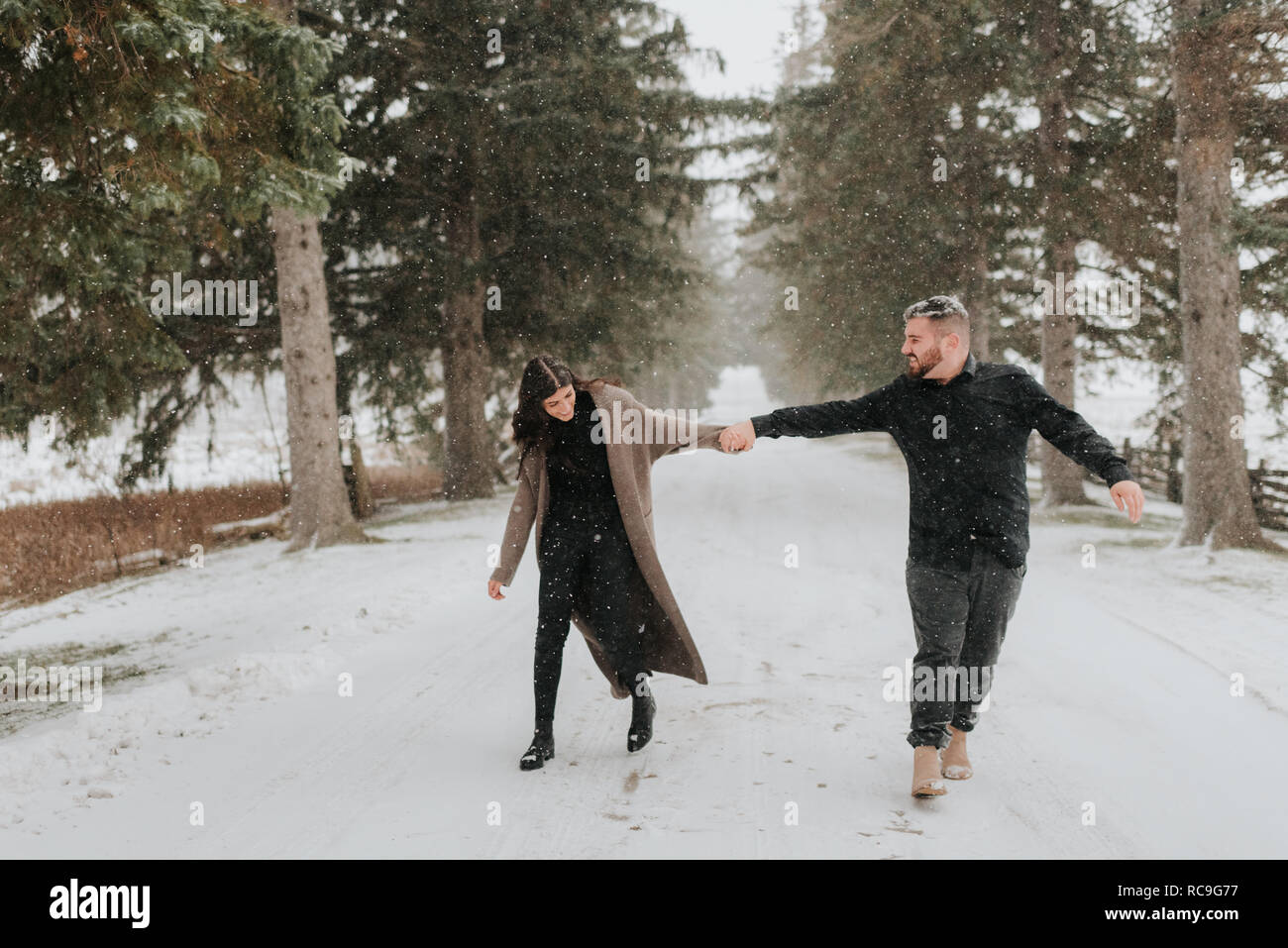 Couple walking in snowy landscape, Georgetown, Canada Stock Photo