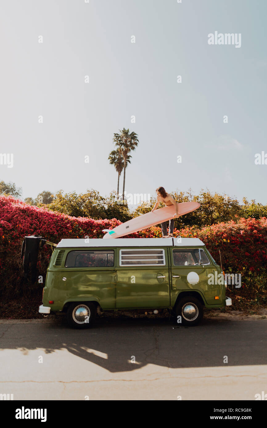 Man on van road trip with his surfboard, Ventura, California, US Stock Photo