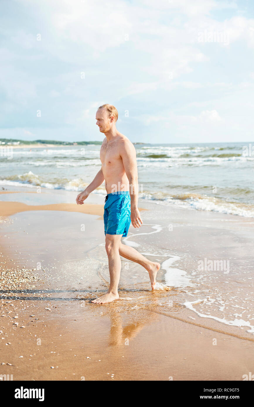 Man walking on beach Stock Photo