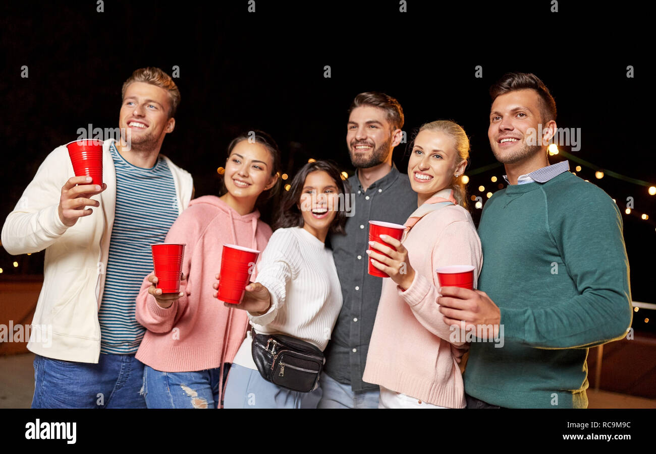 friends with drinks at rooftop party Stock Photo