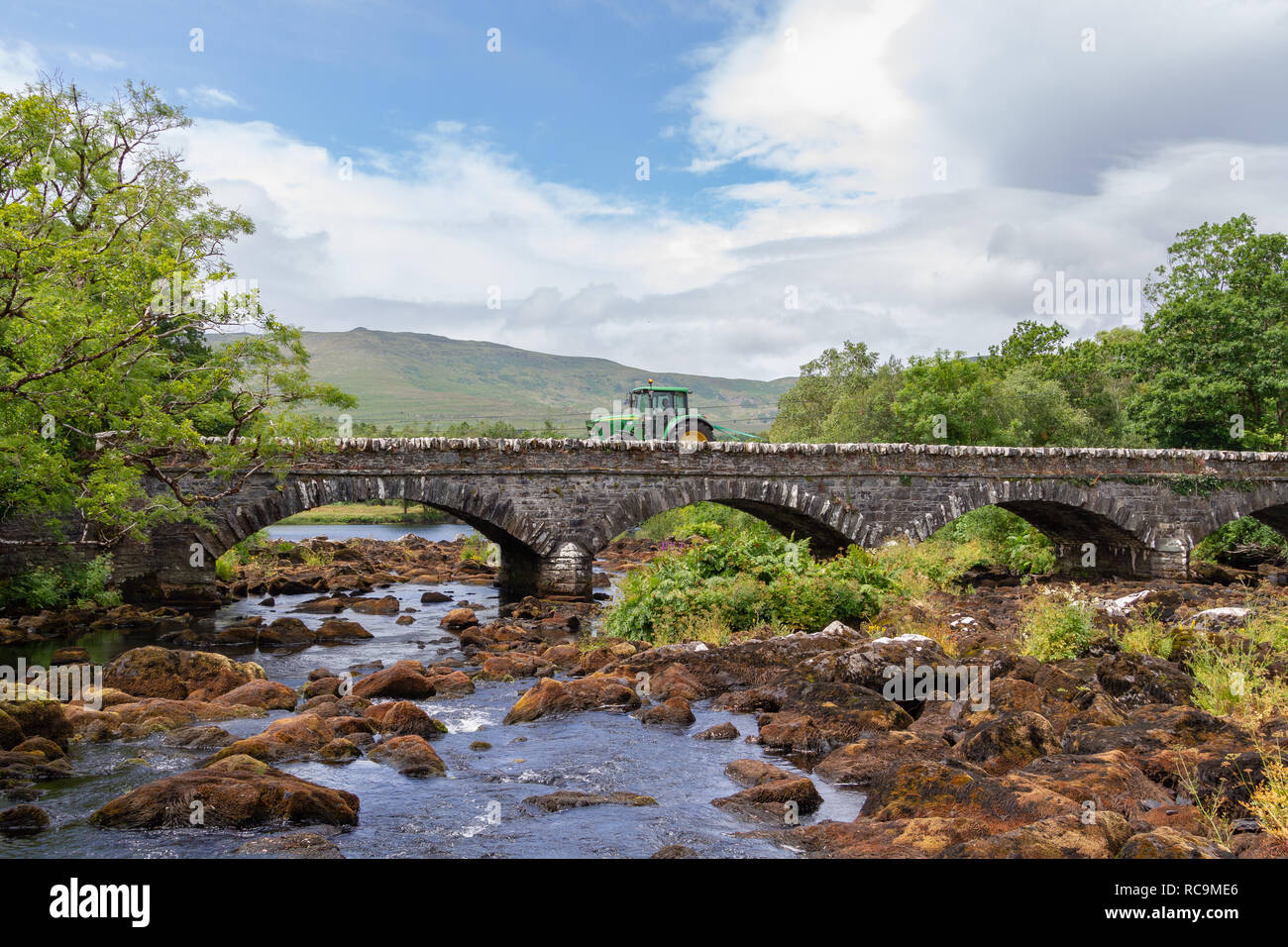 Tractor on the Blackstones Bridge over the Upper Caragh River, Ring of Kerry, Ireland Stock Photo