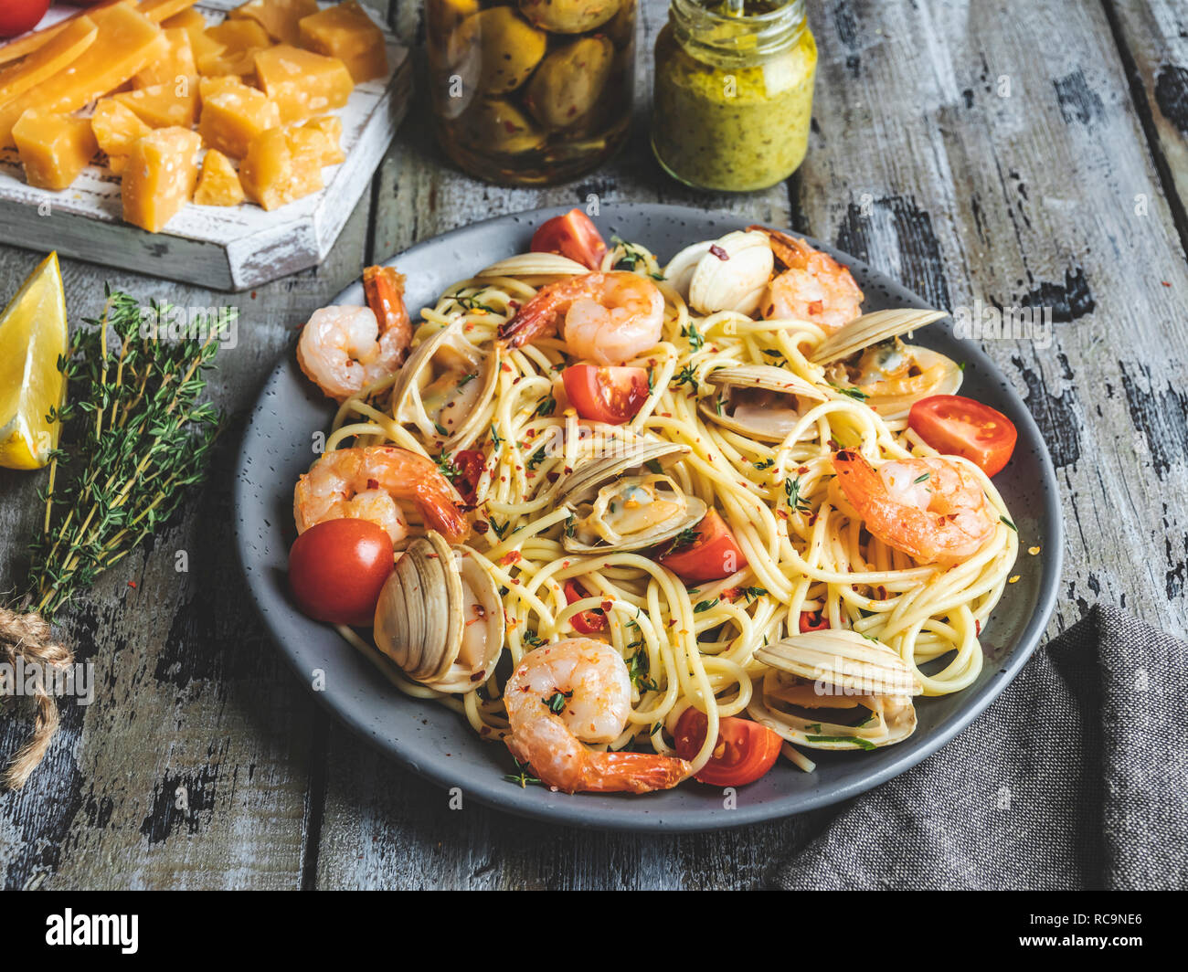 Cooked pasta with clams, shrimps tomato on a plate , spaghetti Stock Photo