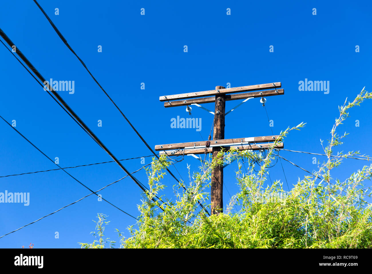 transmission tower and power line over blue sky Stock Photo - Alamy