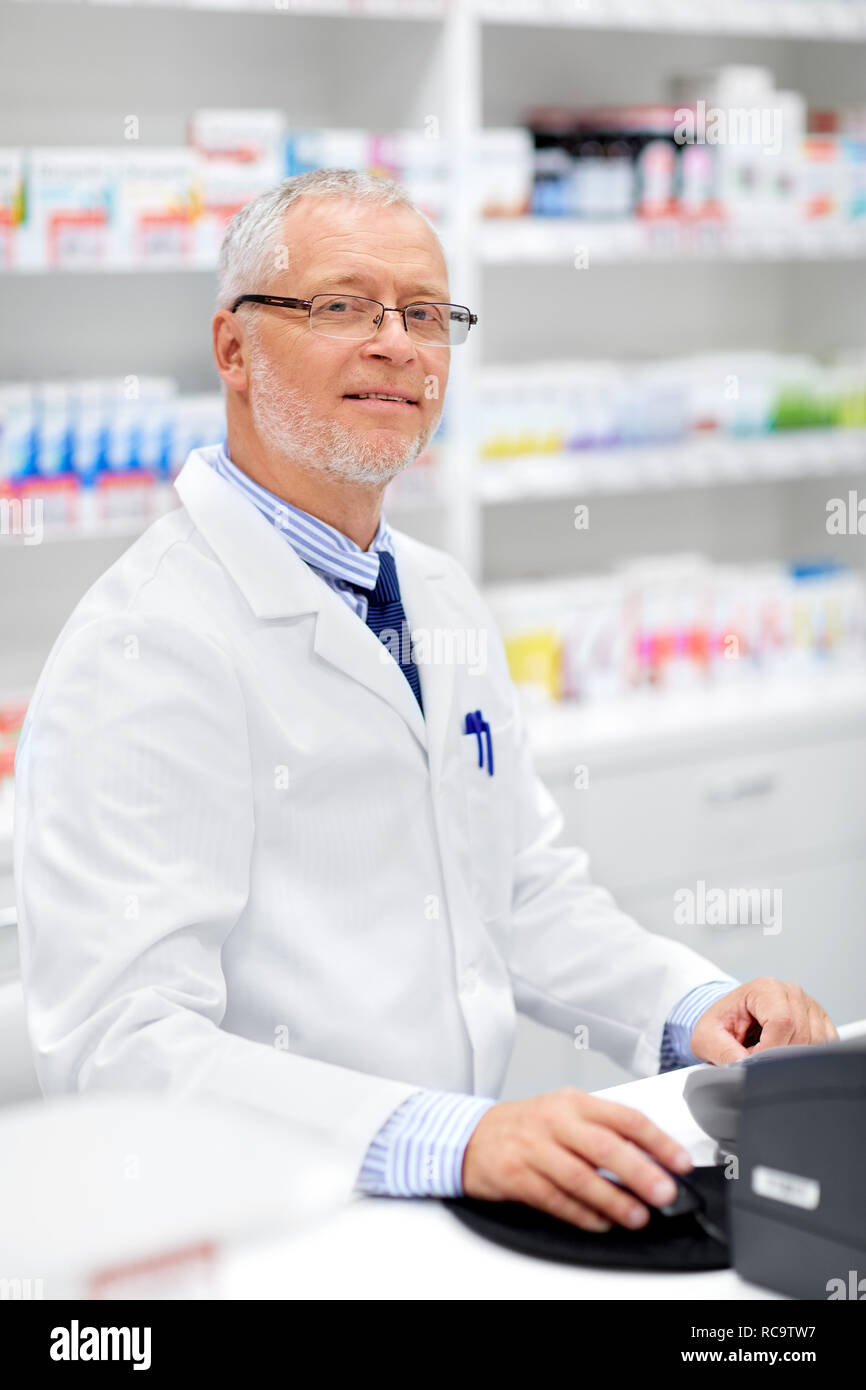 senior apothecary at pharmacy cash register Stock Photo Alamy