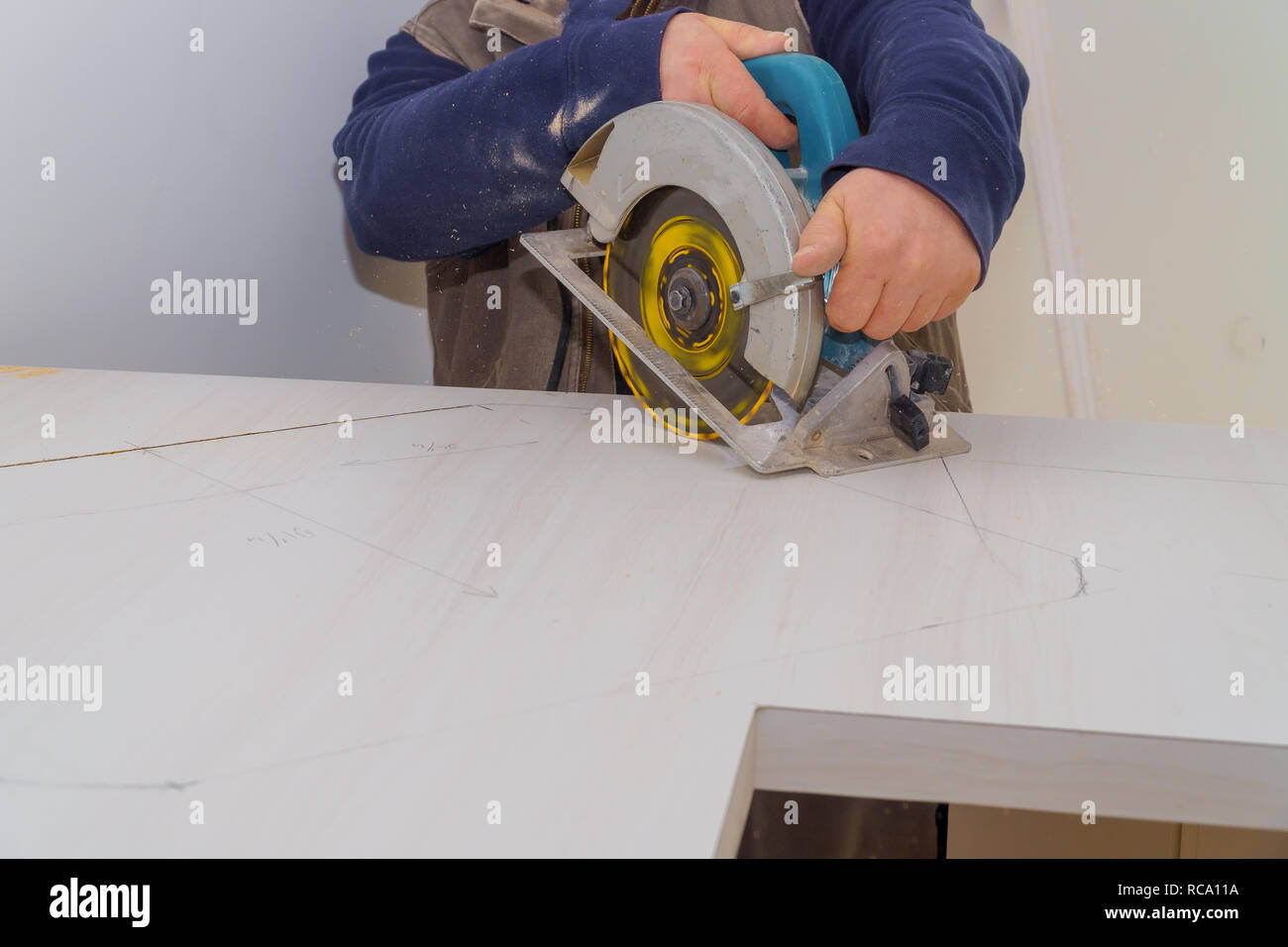 Carpenter Uses A Saw To Cut Laminate Counter Top In The Sink Stock