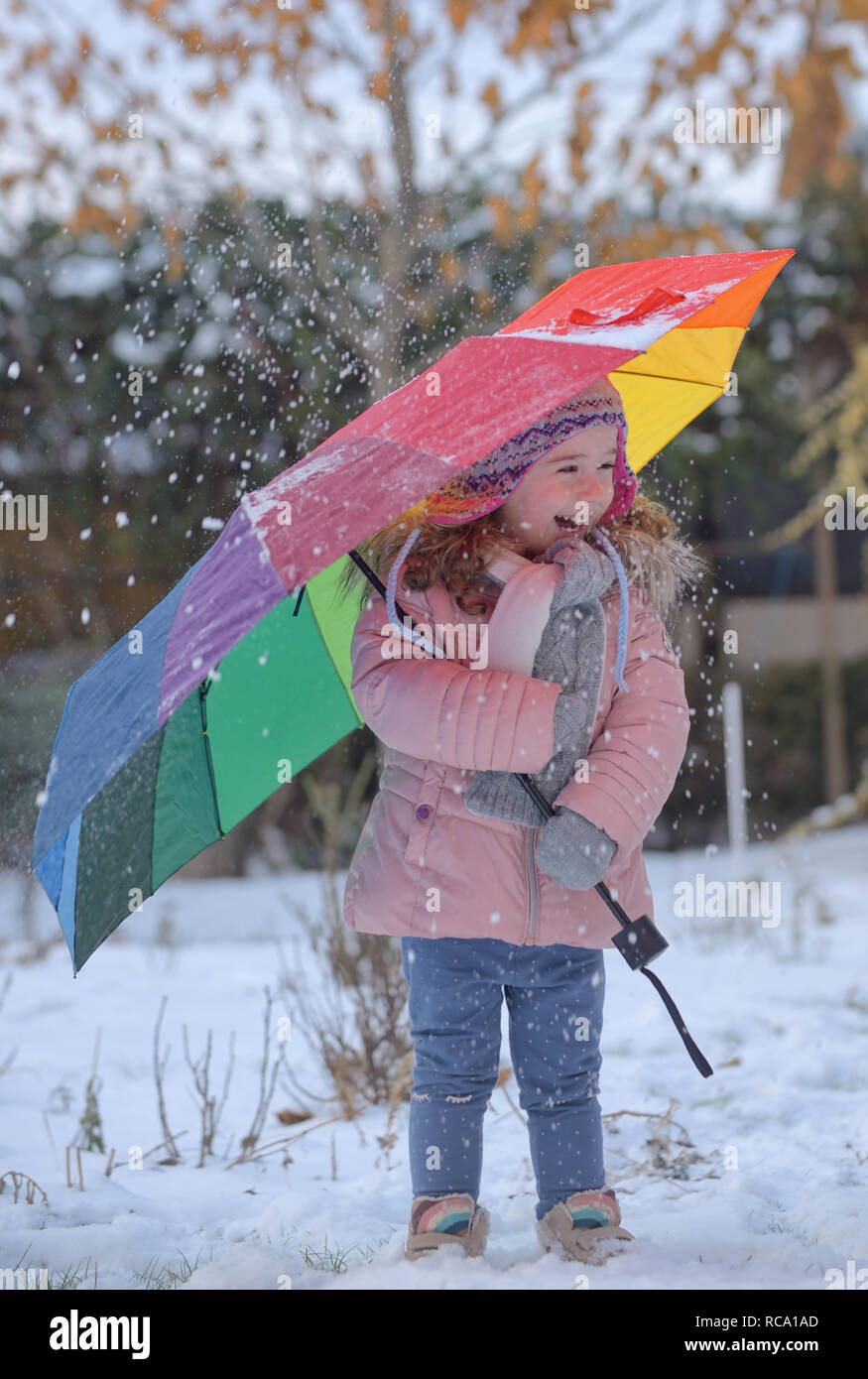 Little girl under umbrella in snowy winter Stock Photo Alamy