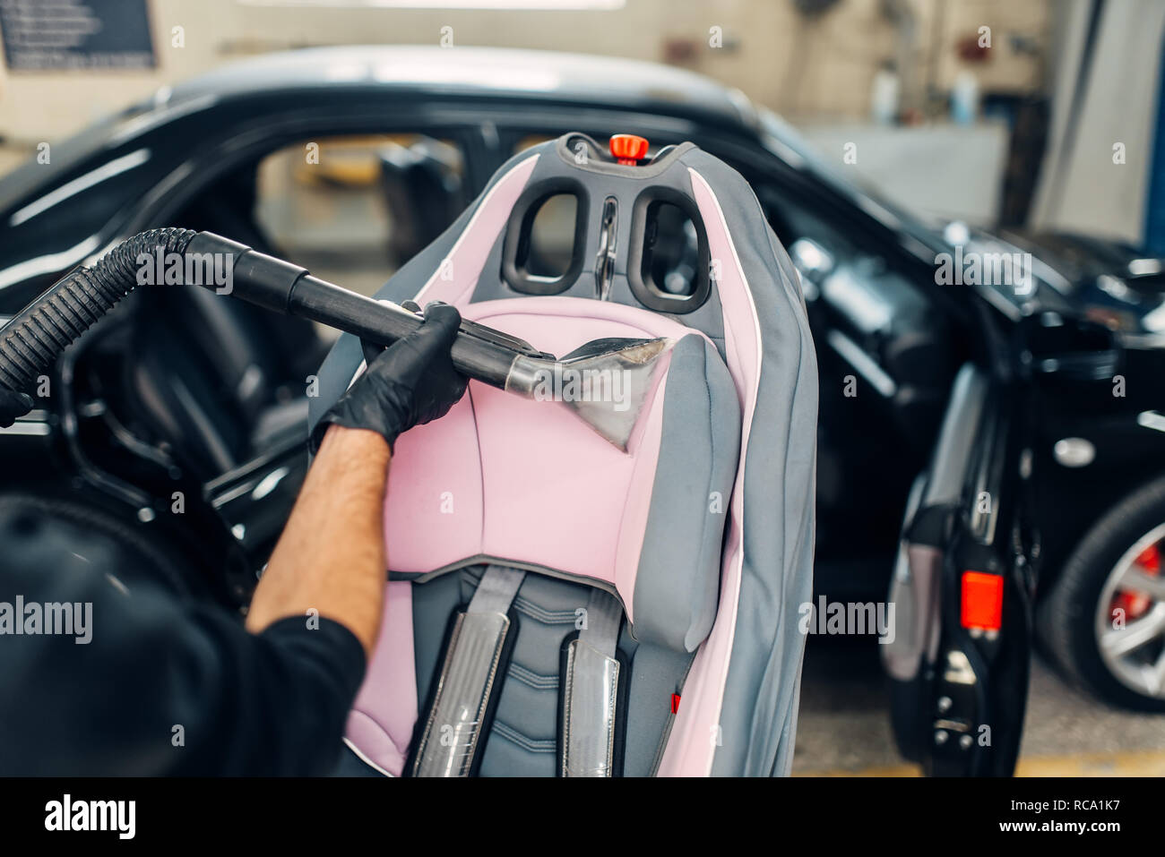 Carwash, Worker Cleans Salon with Steam Cleaner Stock Image