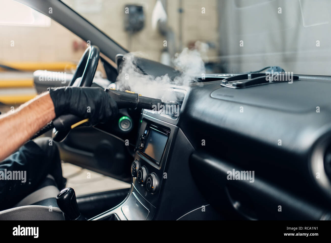 Carwash Service Male Worker In Gloves Removing Dust And