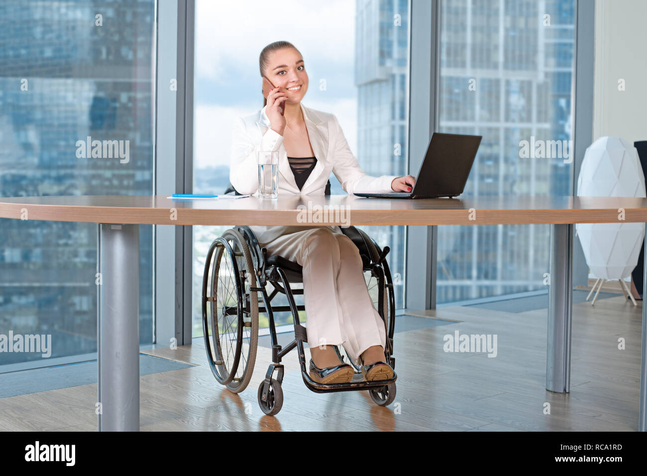 Invalid or disabled young business woman person sitting wheelchair