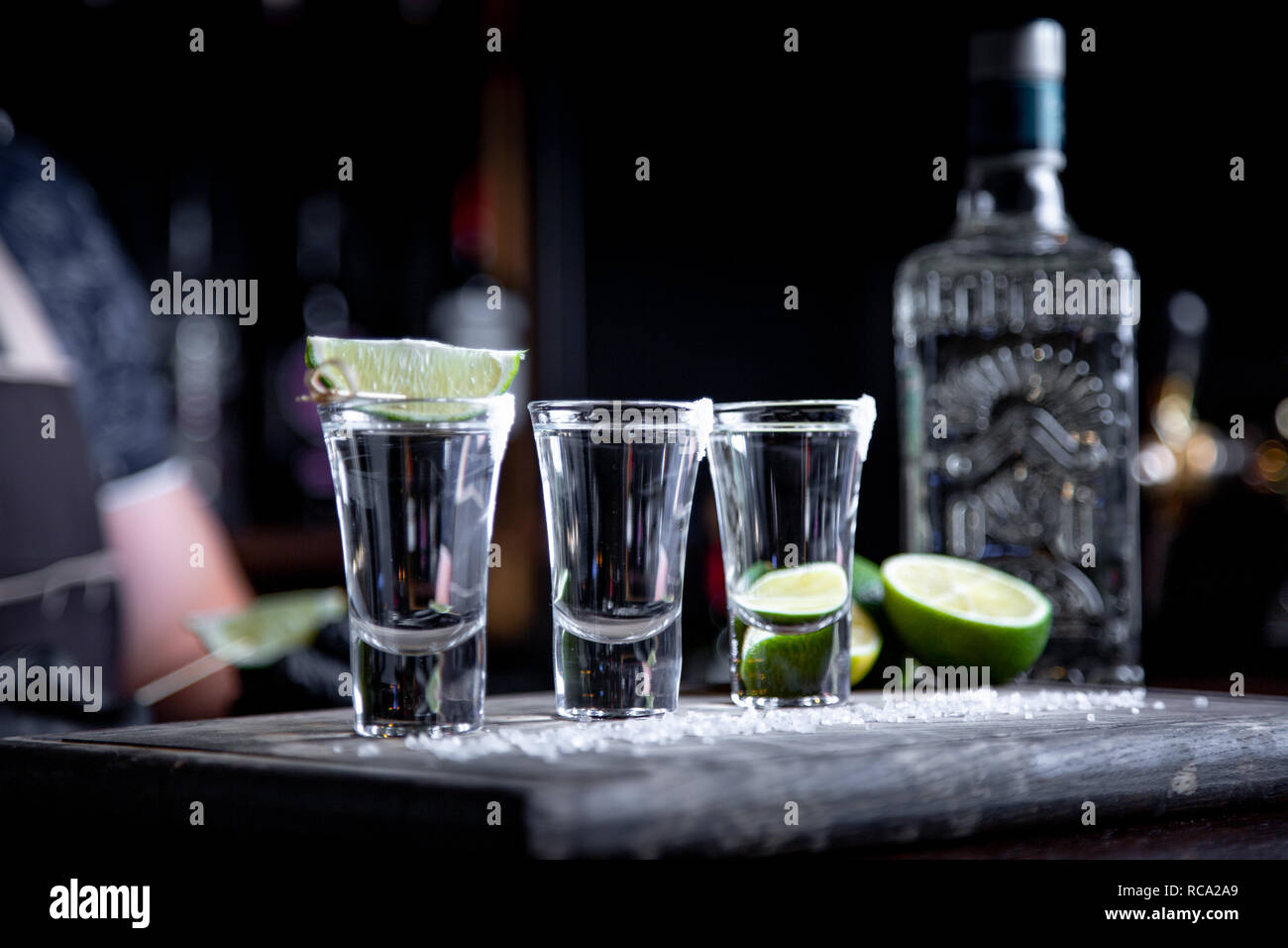 Barman Pouring Hard Spirit Into Small Glasses Such As Alcoholic Shots Of Tequila Or Strong Drink Stock Photo Alamy