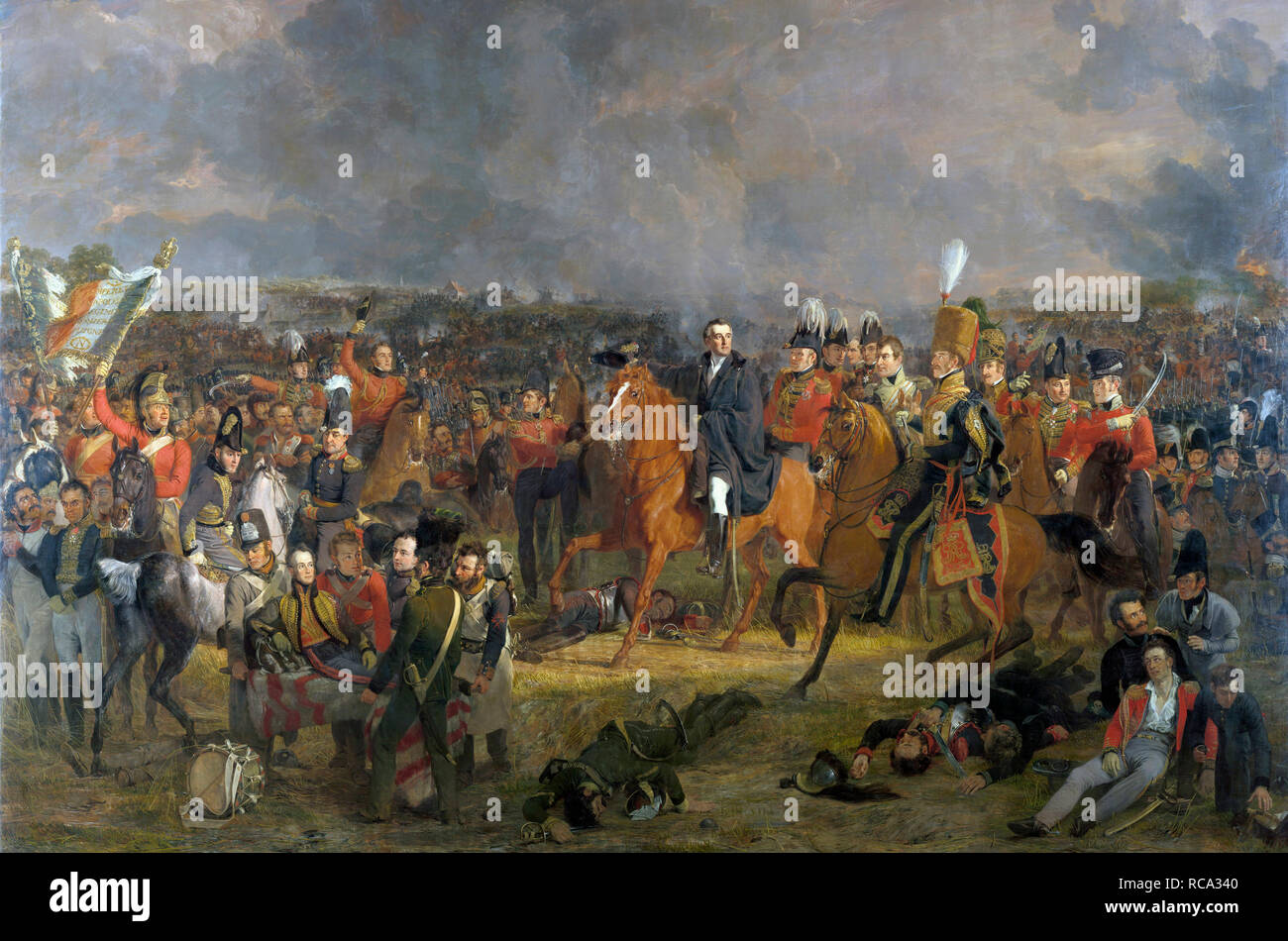 The Battle of Waterloo, after a painting by Jan Willem Pieneman on display in the Rijksmuseum, Amsterdam, Netherlands.  Wellington, centre, receives news that his Prussian allies are close by.  To the left the wounded William, Prince of Orange is carried away on a litter.  The battle rages in the background. Stock Photo