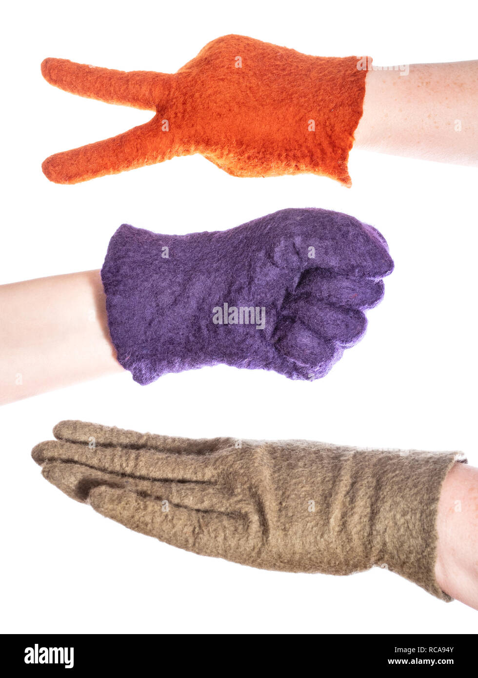 hands in felted gloves show elements of rock-paper-scissors game isolated on white background Stock Photo