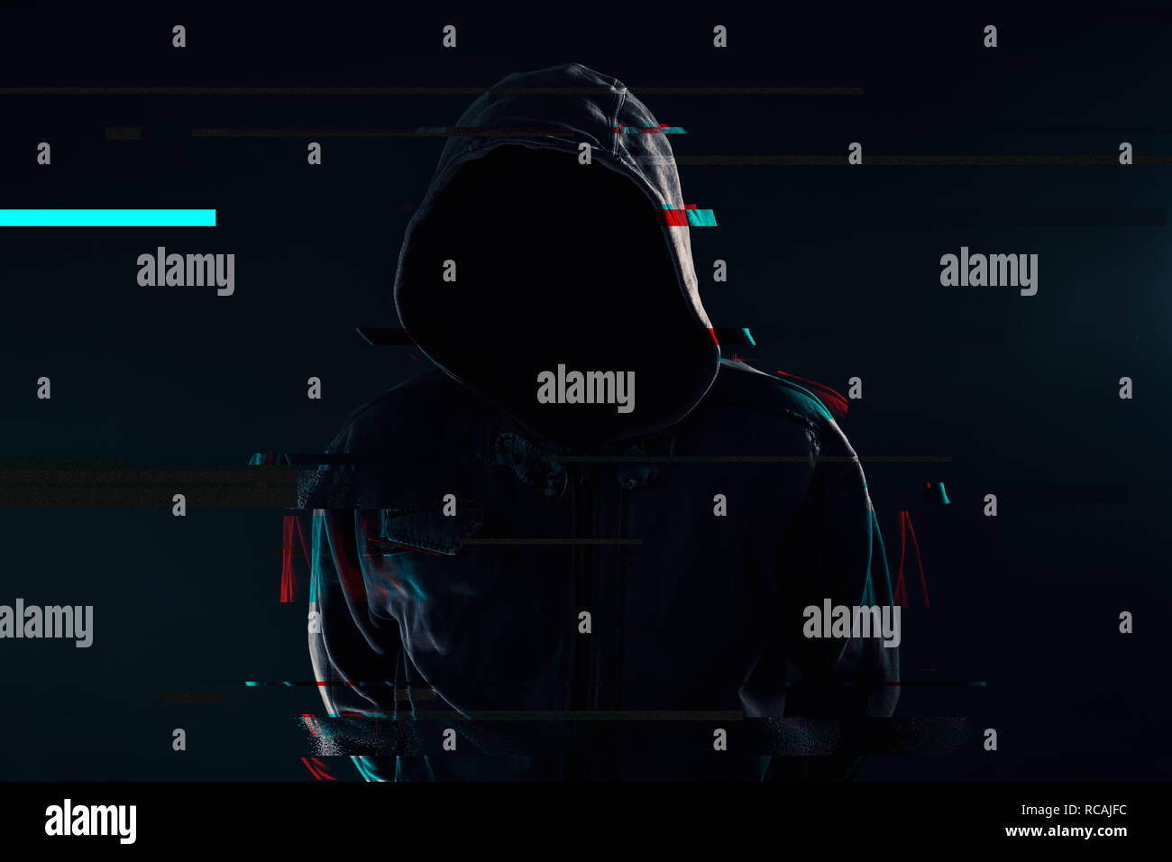Hooded computer hacker with obscured face, glitch effect Stock Photo