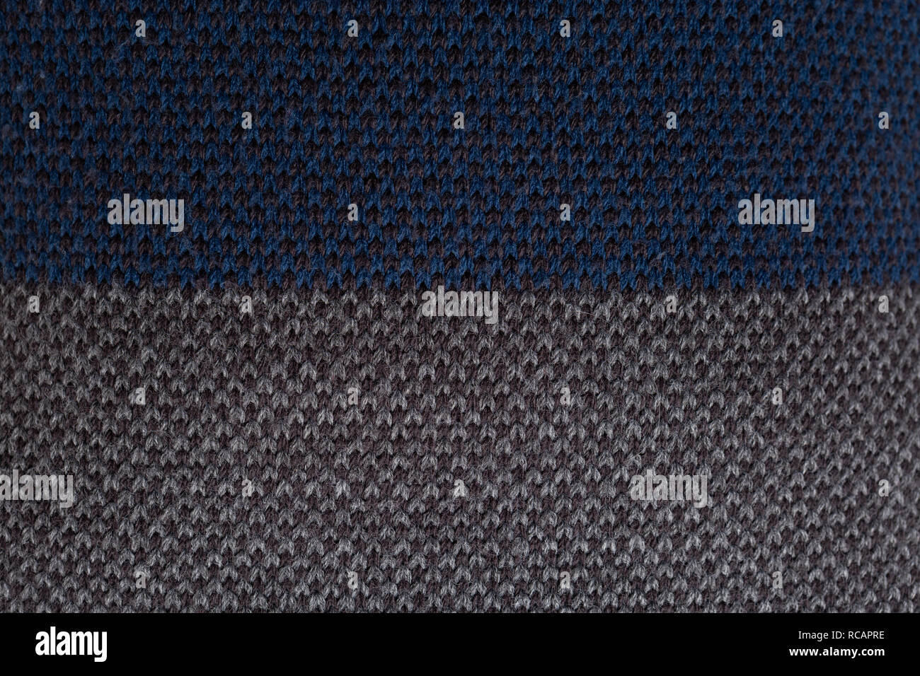 Close-up of blue and grey striped knitted jumper as fashionable winter clothes concept isolated on white studio background Stock Photo