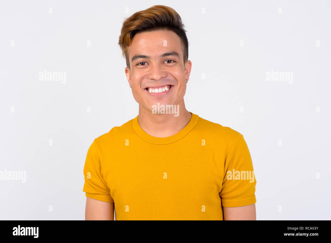 Face of happy young Asian man smiling against white background Stock ...