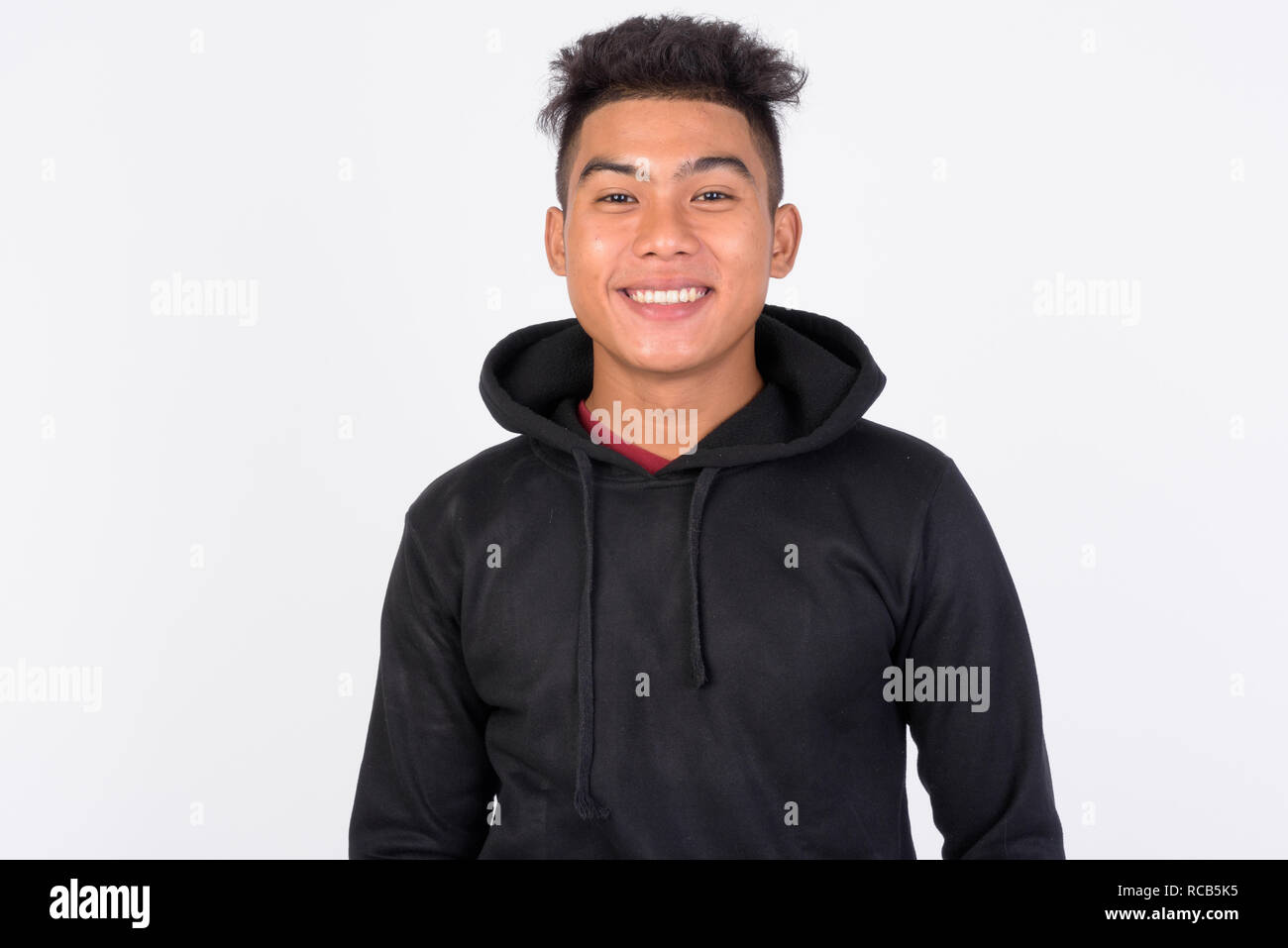 Young happy Asian man smiling against white background Stock Photo - Alamy