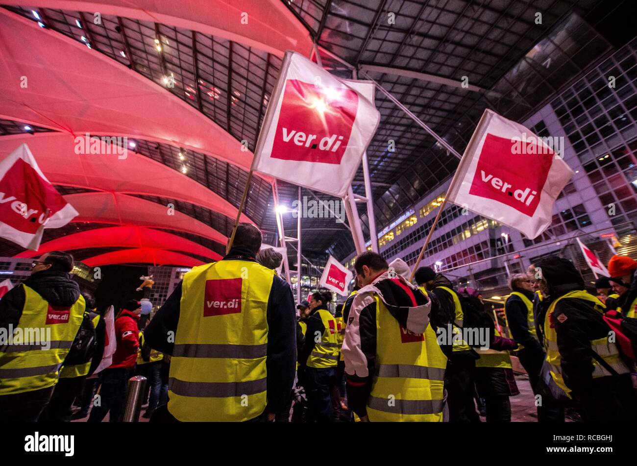 Munich, Bavaria, Germany. 15th Jan, 2019. The flags of the Verdi union representing the striking security workers at the Munich International Airport. Citing a breakdown in talks with employers on December 21st, the German Ver.di union organized the latest warning strike in a series at the Munich International Airport with members employed in Airport Security Services (Luftsicherheit) walking out from 3:30am to 24:00. The union is demanding 20 Euros per hour for their 23,000 total members working in Passenger-, Freight, Personnel, and Goods Control of Airport Security, along with recertif Stock Photo