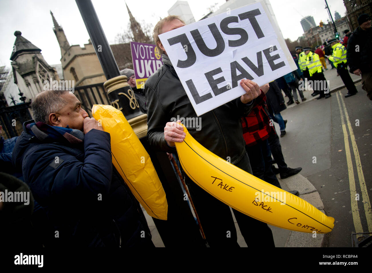 Westminster, London, UK. January 15th 2019. Demonstrations outside the Houses of Parliament as MPS vote on PM Theresa May's Brexit deal. UKIP supporters with blow-up bananas saying 'Take back control' ( they believed the EU had demanded bananas be straight) and a sign saying 'Just leave'. Credit: Jenny Matthews/Alamy Live News Stock Photo