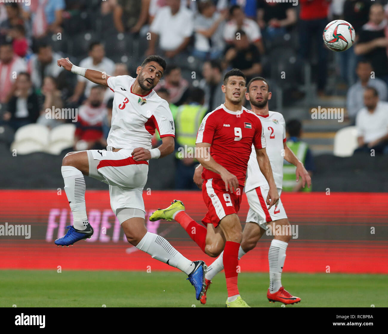 Abu Dhabi, United Arab Emirates. 15th Jan, 2019. Jordan's Tareq Khattab (L)  heads for the ball during the 2019 AFC Asian Cup group B match between  Palestine and Jordan at the Mohammed