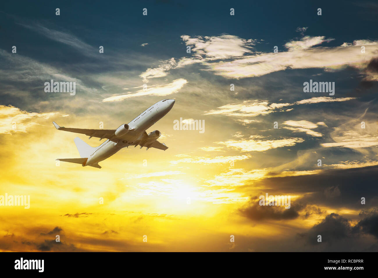 Aircraft fly high above the golden clouds during the sunset passenger ...