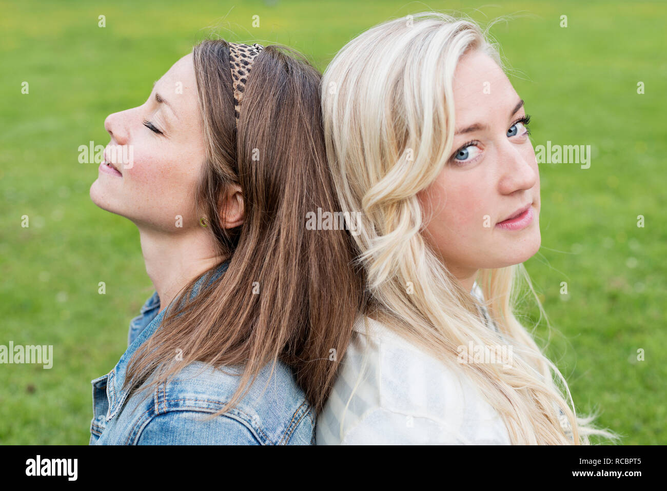 Portrait of young women in park Stock Photo - Alamy