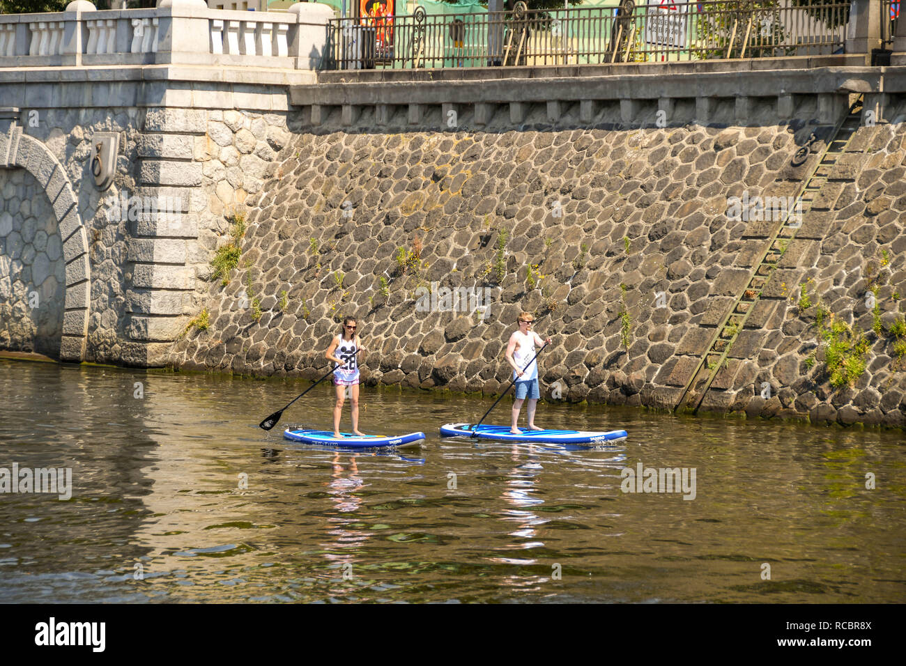 PRAGUE, CZECH REPUBLIC - JULY 2018: two people paddle boarding on the River Vltava in Prague. Stock Photo