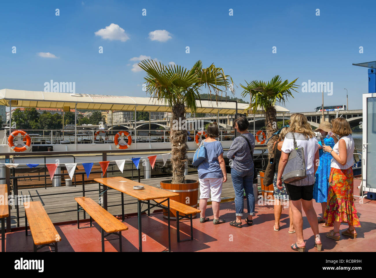 PRAGUE, CZECH REPUBLIC - JULY 2018: Group of people waiting to board a sightseeing river cruise boat on the River Vltava in Prague. Stock Photo