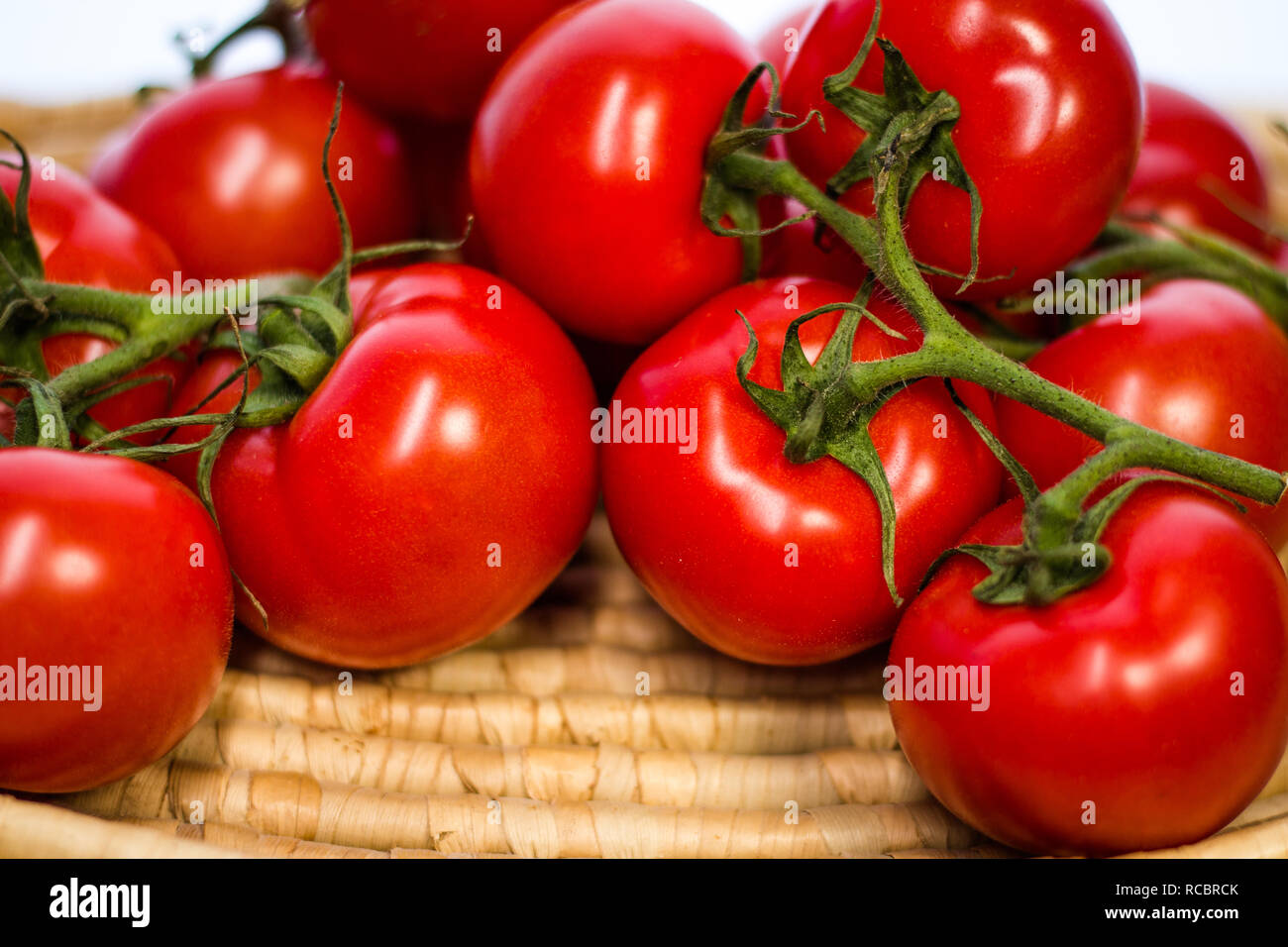 Tomato clusters on the vine. Stock Photo