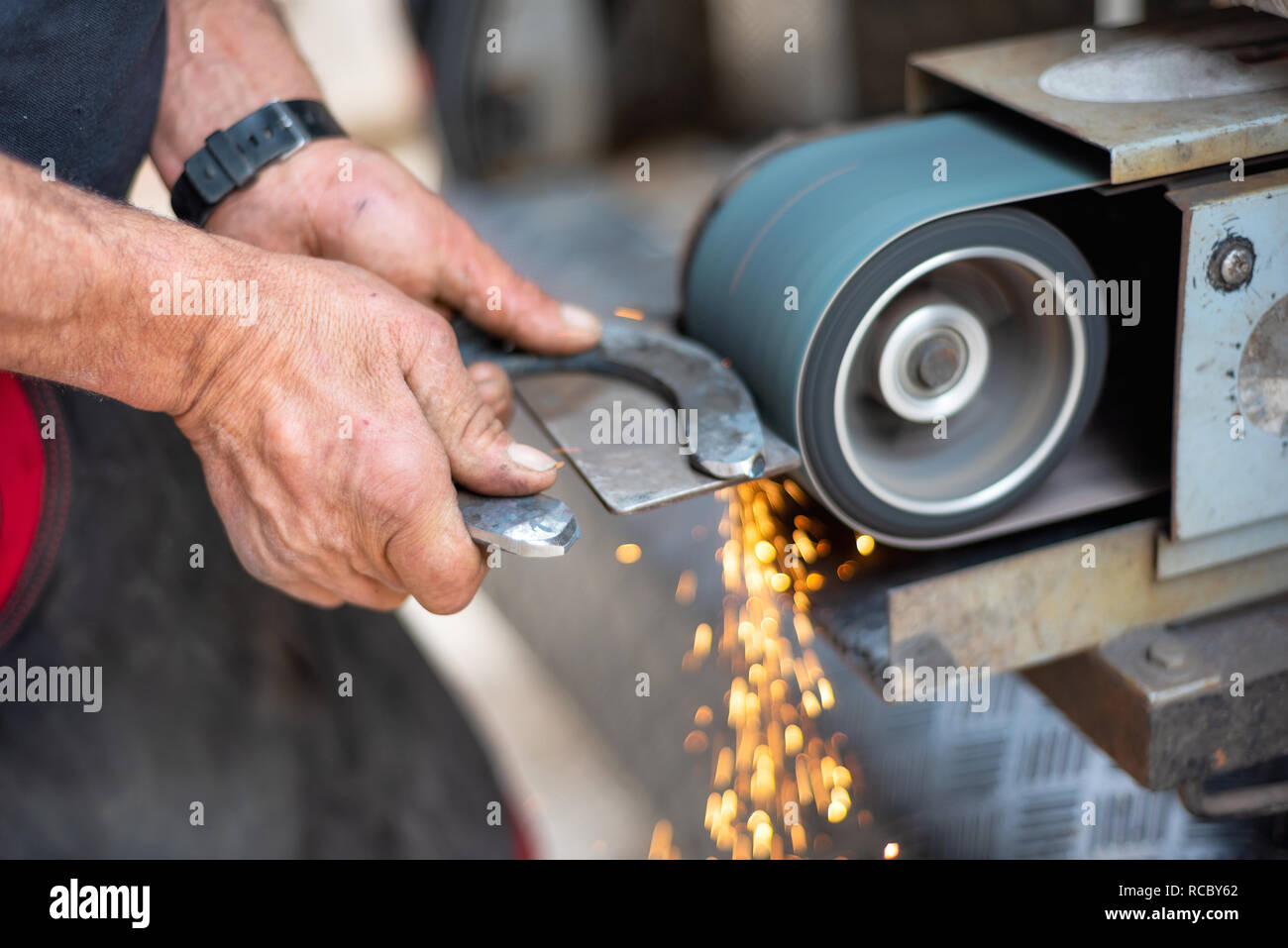 Metal working industry. Finishing metal surface on grinding machine