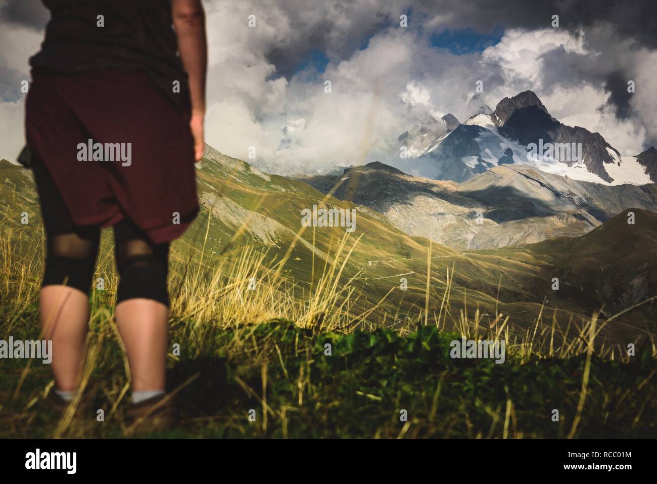 Woman stood looking at Mont Blanc, France in the summer grass Stock Photo