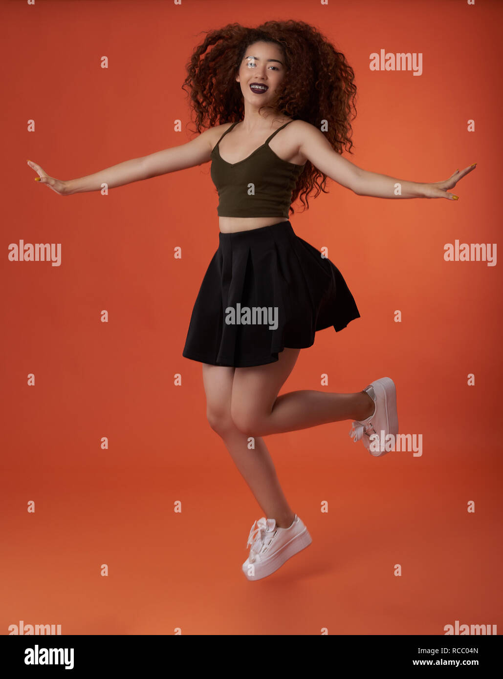 Young woman happy jump. Happy smiling girl in air Stock Photo