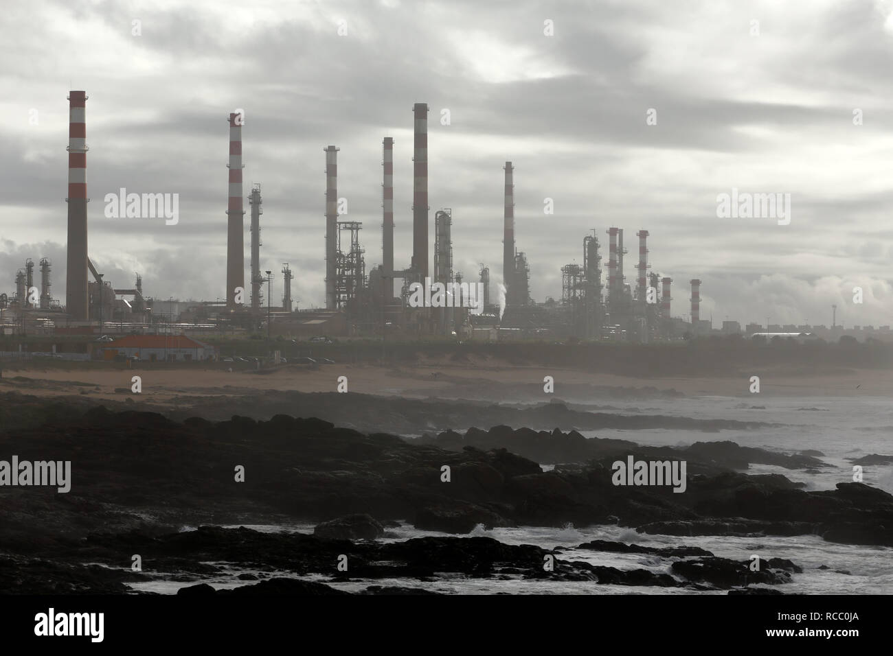 Part of an oil big refinery near the sea in the middle of smog Stock