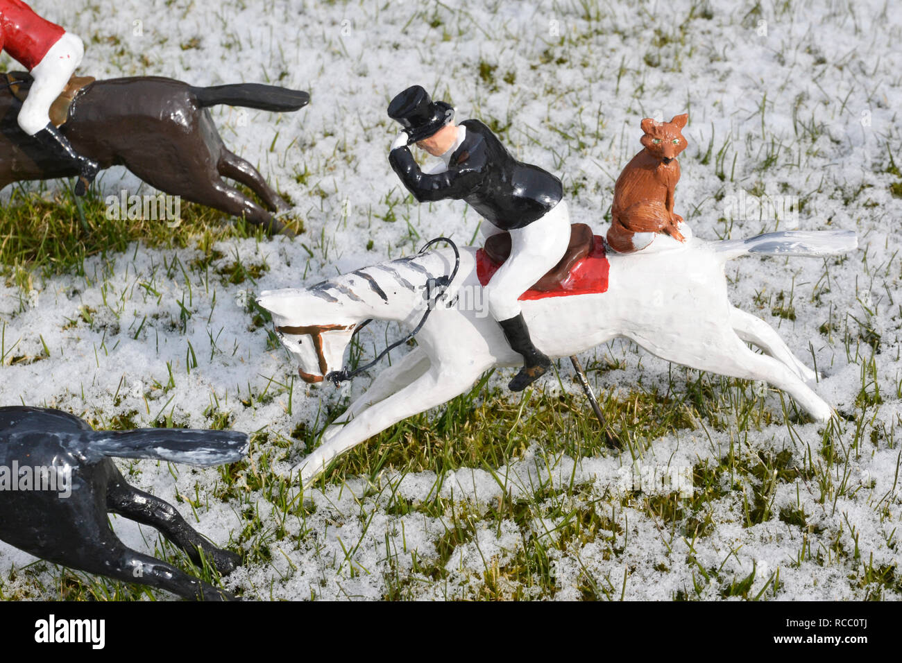 Fox outwitting the hunters at Bekonscot Model Village, Beaconsfield, Buckinghamshire, UK. In winter snow. Stock Photo