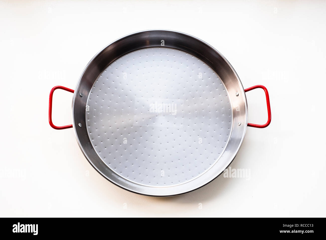 New unseasoned carbon steel paella pan, isolated on white top view Stock Photo