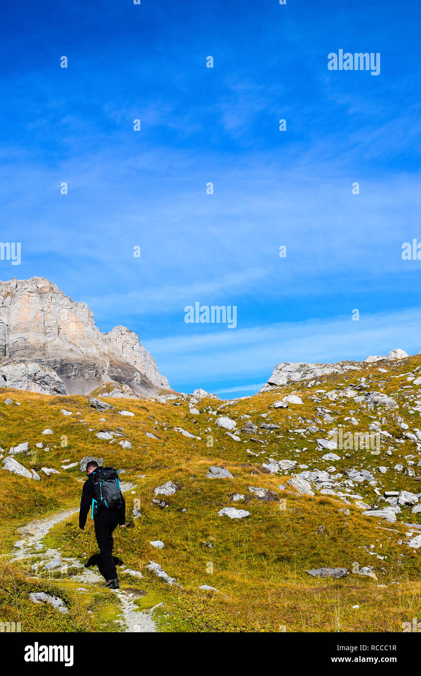 Hiker in the region of Torrenthorn, with a stunning view of the swiss alps, Switzerland/Europe Stock Photo