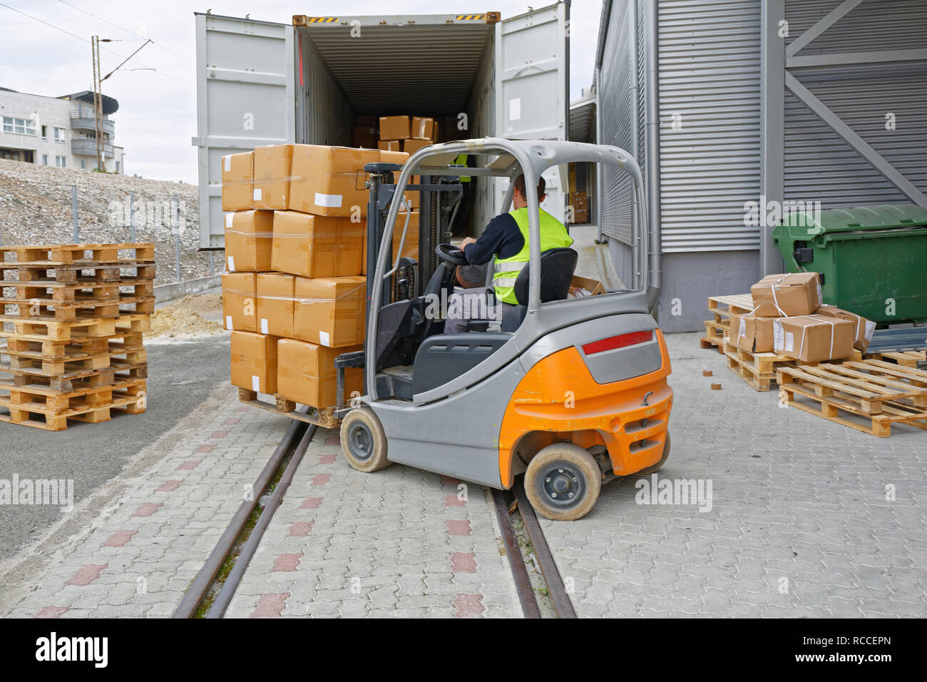 Loading Boxes at Pallet With Forklift in Cargo Container Train Stock Photo