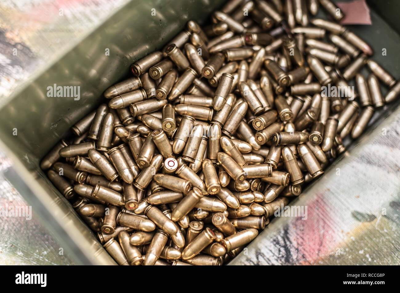 Top view of box with ammunition for gun on the table. Bullets for
