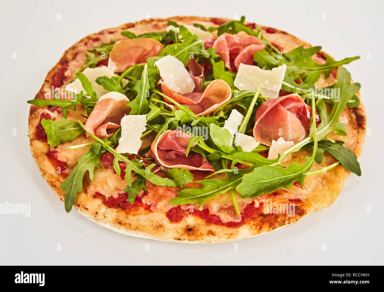 Delicious rocket and prosciutto Italian pizza on a crispy thin base