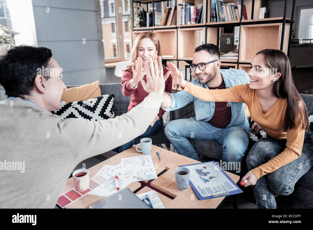 Cheerful team giving a high-five Stock Photo