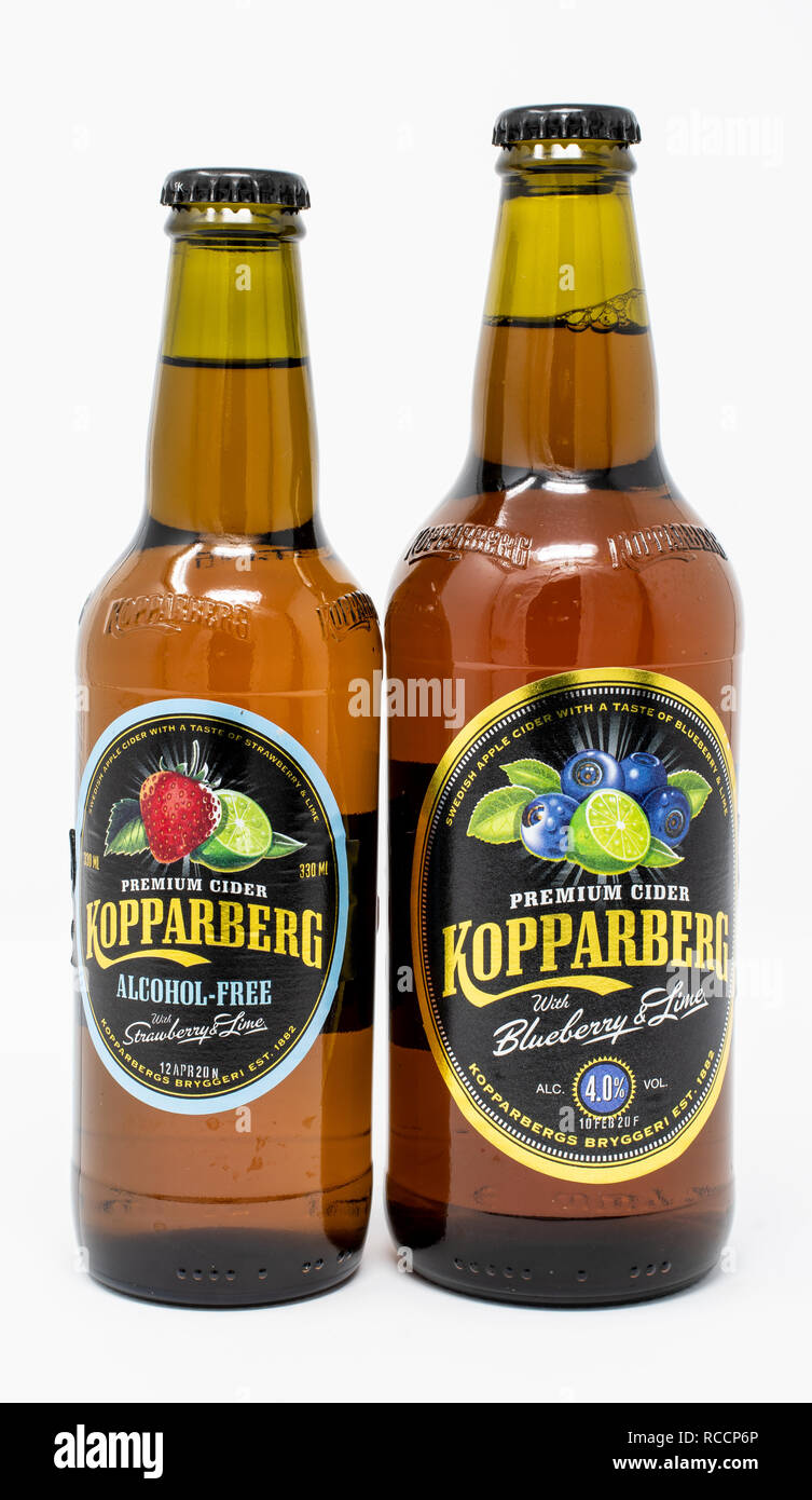 Reading, United Kingdom - December 30 2018:   Two bottles of Kopparberg fruit cider, one alcohol free strawberry and ime and one normal blueberry and  Stock Photo