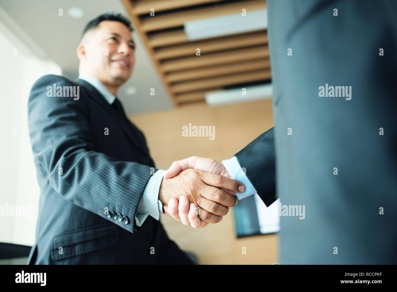 Manager Shaking Hands With Colleague After Business Meeting For Contract Stock Photo