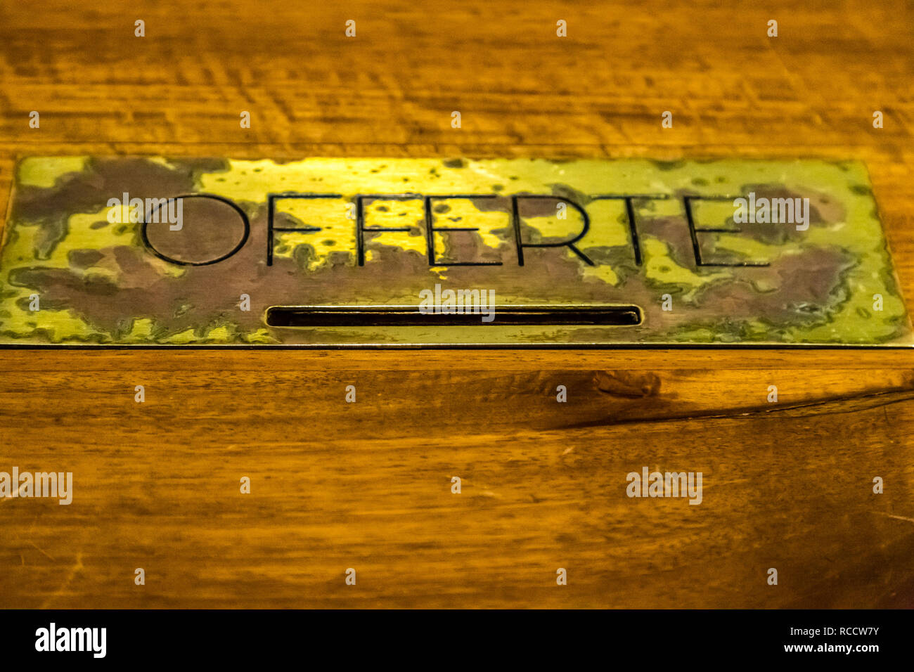 Box of offerings in a church with metal label with Italian word meaning