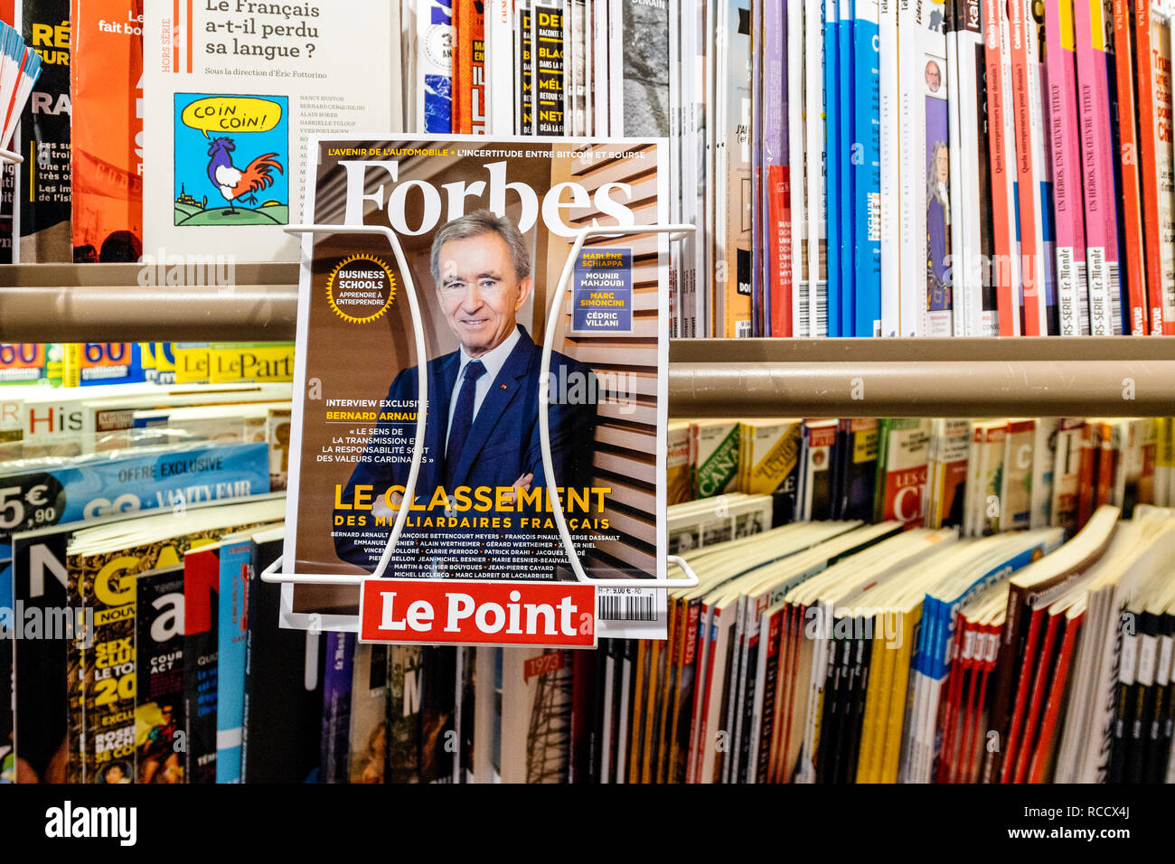 PARIS, FRANCE - MAR 15, 2018: Top of billionaires in France as of Forbes Magazine with portrait of LVMH owner Bernard Arnault at press kiosk Stock Photo