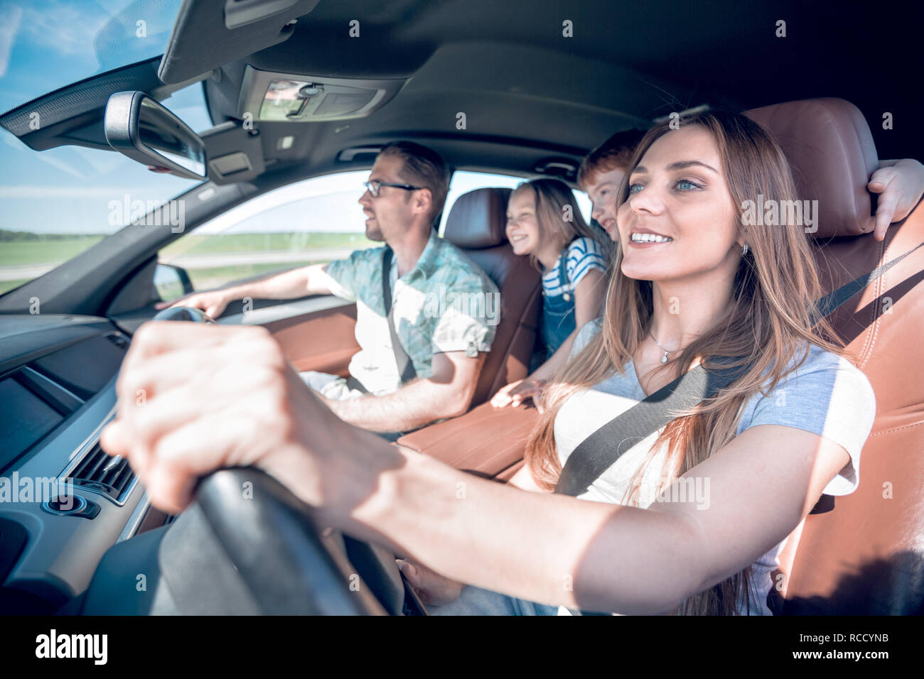 happy mom driving a family car Stock Photo - Alamy